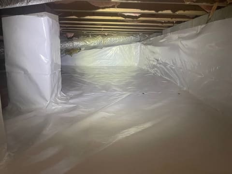 Finished crawl space encapsulation with vapor barrier walls and dehumidifier — completed by Crawl Daddy in Metro Atlanta