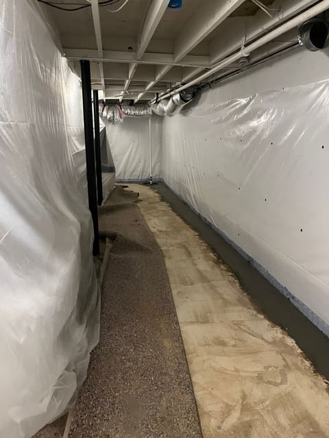 Finished basement waterproofing with perimeter drain, vapor walls, and sump system — Crawl Daddy install, Metro Atlanta